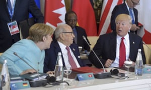 Donald Trump with Angela Merkel and Tunisian president Beji Caid Essebsi at the G7 summit. Merkel said: ‘The whole discussion about climate has been difficult, or rather very unsatisfactory.’