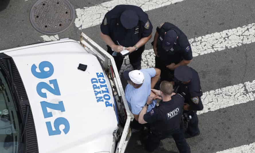 New York City police officers detain and question a man in the Bronx.