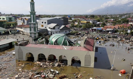 People survey the mosque damaged following earthquakes and tsunami in Palu