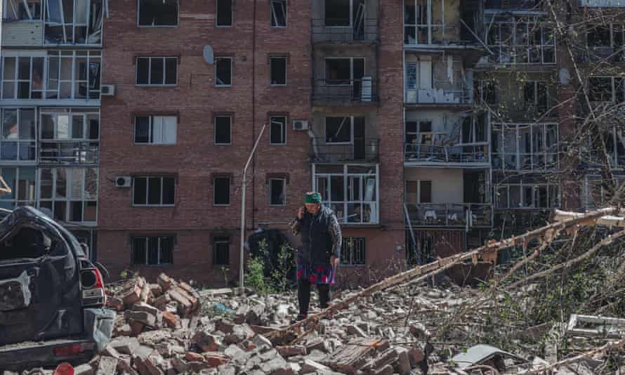 A woman walks through the rubble of a destroyed building after a bombing in Bakhmut, Ukraine.