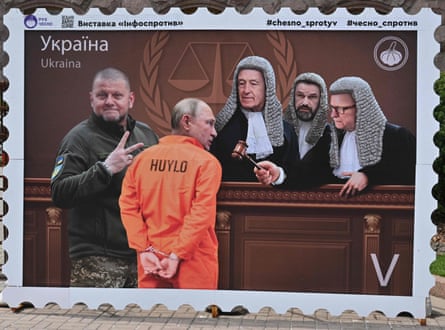 A placard resembling a postage stamp depicting Gen Valerii Zaluzhnyi, flashing a V-sign beside a handcuffed Vladimir Putin before the judges at a Hague court.