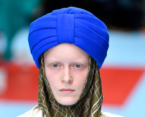 A model wearing a Gucci turban-style hat