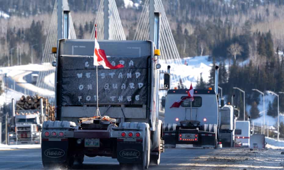 Protesters drive over the Nipigon Bridge on the Trans Canada Highway as part of a trucking convoy against Covid vaccine mandates on 27 January.