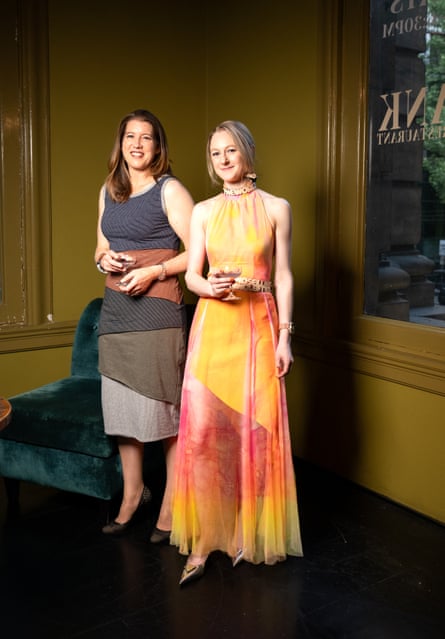 Lisa Howard (right) in her painted silk dress. The belt and necklace feature song lyrics by her husband.