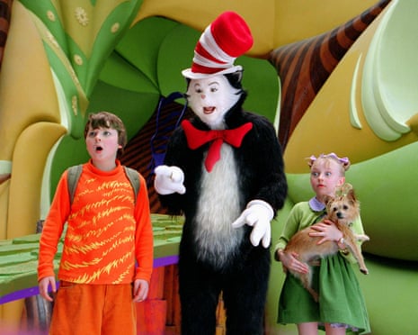 film still of cat in the hat pointing as young boy and girl look ahead with surprise