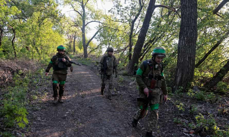 Ukrainian servicemen patrol an area in an undisclosed location in the Kharkiv region of Ukraine on Tuesday.
