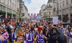 Protesters march with placards in support of trans people during a demonstration in Piccadilly Circu