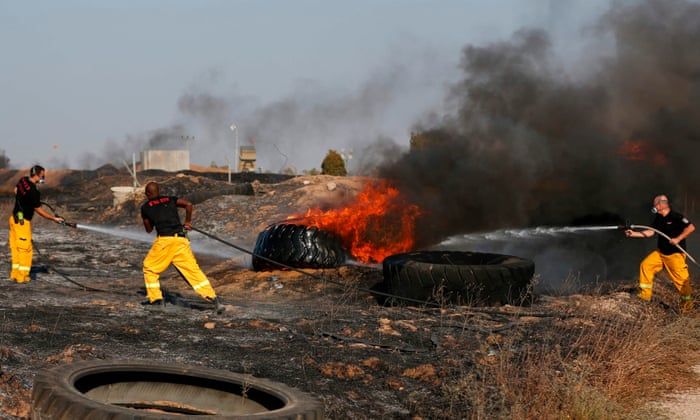Israeli firefighters put out a tire fire along the border with the Gaza Strip after they were started by Palestinians during clashes with Israeli forces
