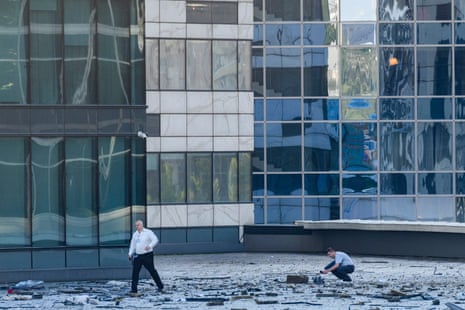 Investigators examine an area next to a damaged building in the "Moscow City" business district.