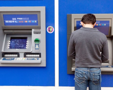 A man getting cash from a Halifax bank ATM cash machine, Norwich UK<br>DH09BT A man getting cash from a Halifax bank ATM cash machine, Norwich UK