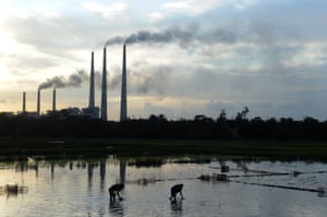 Indian labourers planting rice in front of Kolaghat Thermal Power Plant, 85km south-west of Kolkata.