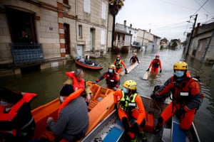 Saintes, France: Rescuers on small boats help residents in a flooded area as the Charente river overflows.