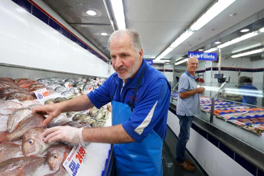 Con Doukas arranges a fish display at Musumeci Seafoods at the Sydney Fish Market ahead of Easter long weekend celebrations.