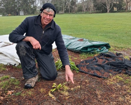 Man points at the ground while searching for a meteorite