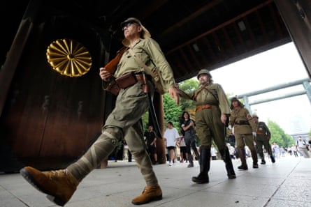 Visitors in Japanese Imperial army costume enter the Yasukuni Shrine in 2023.