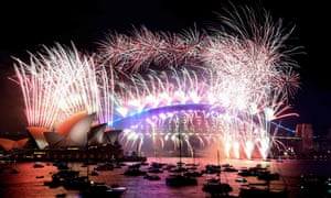Sydney, Australia. Fireworks light up the sky over Harbour Bridge and the Sydney Opera House as the Australia celebrates New Years Eve.