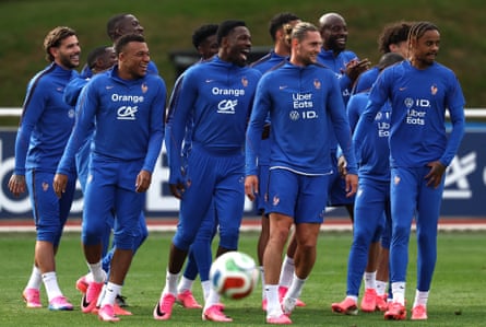 The French players wear their bright blue training kit and stand together on a pitch