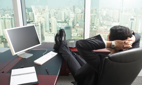Businessman with feet up on desk in office