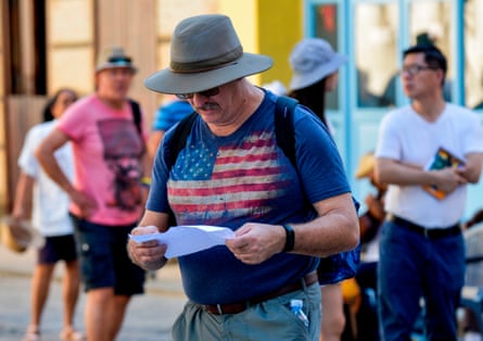 A man wearing a shirt depicting the US flag walks along a street of Havana, on December 10, 2019.