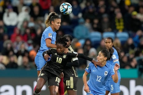 France's Maelle Lakrar, left, Jamaica's Jody Brown and France's Clara Mateo battle for the ball.