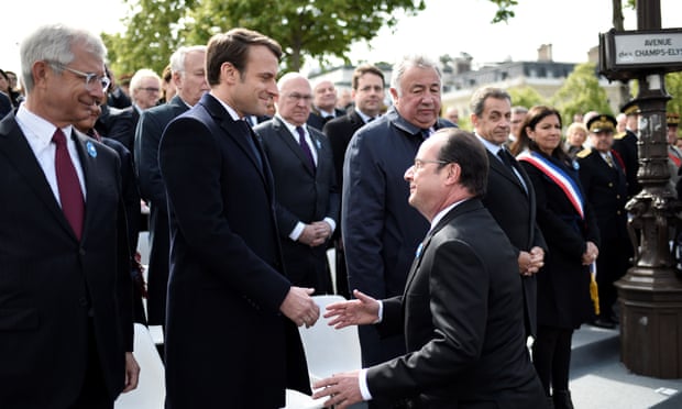 The outgoing French president, François Hollande (centre right), arrives to shake hands with Emmanuel Macron.