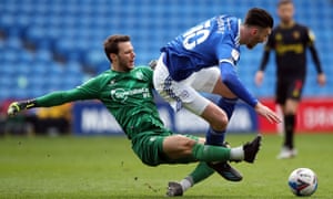 Watford goalkeeper Daniel Bachmann takes out Cardiff City’s Kieffer Moore and goes in the ref’s book.