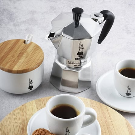A Bialetti Moka Express Italian Stovetop Espresso Maker with cups of coffee