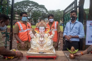 BMC workers prepare to take a statue to be immersed after its ornaments have been removed.