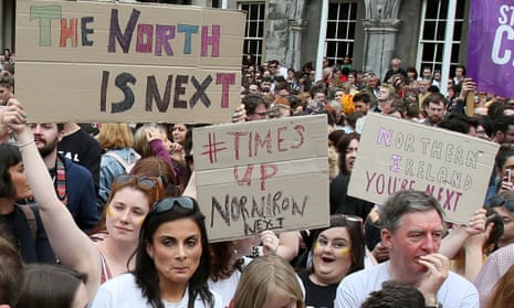 Campaigners hold posters calling for Northern Ireland to liberalise its strict abortion laws