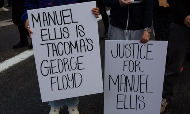 People hold signs reading ‘Manual Ellis is Tacoma’s George Floyd’ and ‘Justice for Manuel Ellis’ in Tacoma, Washington last June. 