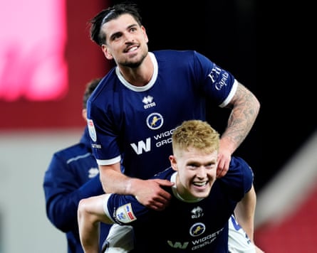Josh Coburn gives Tristan Crama a piggyback after the Championship match between Stoke and Millwall