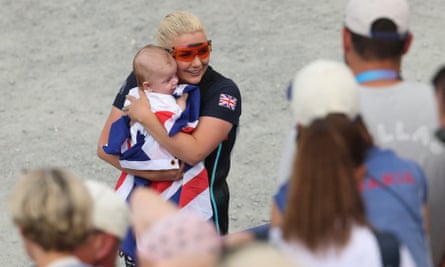 Amber Rutter holds her baby son and a British flag.