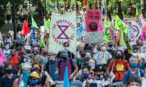 Extinction Rebellion protesters march to Parliament Square in central London.