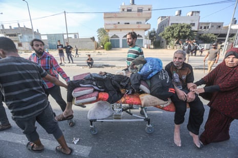 Palestinians push injured elderly people on a bed they took from the hospital as they flee with other Palestinian families in Gaza City and other parts of northern Gaza towards the southern areas amid ongoing battles between Israel and the Palestinian Hamas movement. 10 Nov 2023