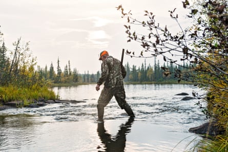 Hunter crossing river, Sweden