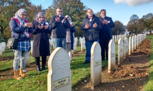 Visitors pray over the Muslim graves at Notre Dame de Lorette.