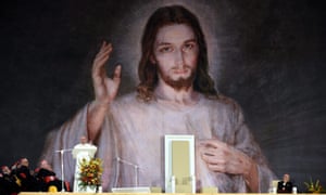 Francis addresses the crowd in front of a giant image of Jesus.