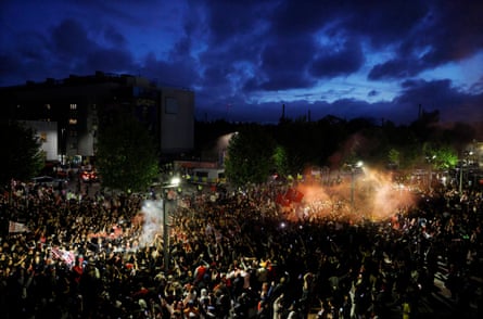 Arsenal fans celebrate winning the Premier League outside the Emirates Stadium.
