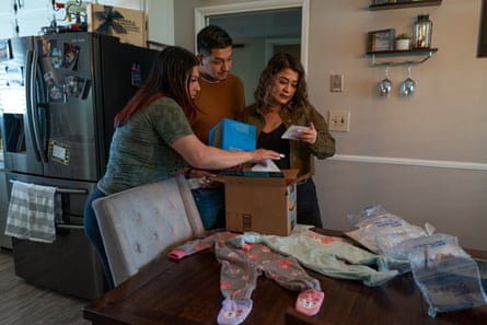 Miguel, Alexis, and Alexis's mom, open baby gifts at their families house in Clovis, California.