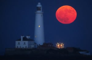 Full moon by a lighthouse