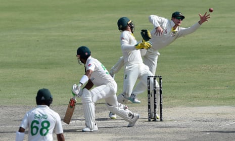 Steve Smith (right) takes the catch to dismiss Pakistan's captain Babar Azam (second left) during the fifth and last day of the third and final Test cricket match between Pakistan and Australia at the Gaddafi Cricket Stadium in Lahore on 25 March 2022