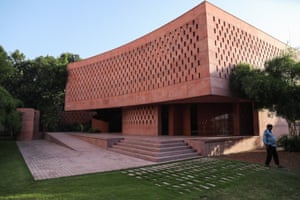 Rose-colored cement building with many openings in the outer walls