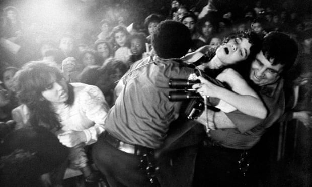 A yung woman faints during a Menudo concert at Madison Square Garden, New York City.