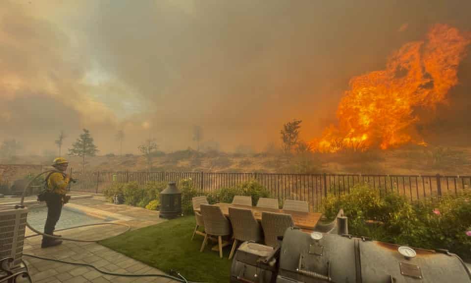 A firefighter prepares to battle the North fire from a backyard on Via Patina, in Santa Clarita, California in April.