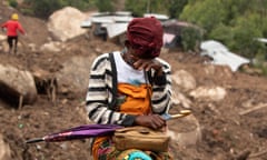 A woman weeps amid upturned rocks and earth at a cyclone-affected area in Blantyre, Malawi, on 17 March.