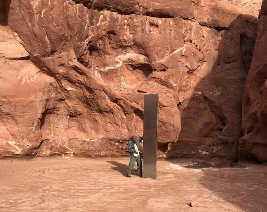 A Utah state worker next to the red rock country monolith.