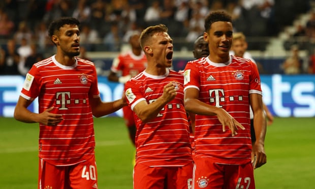 Jamal Musiala celebrates with Joshua Kimmich and Noussair Mazraoui after scoring Bayern's sixth.