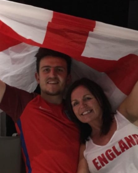 Harry Maguire and his mother Zoe wave an England flag.