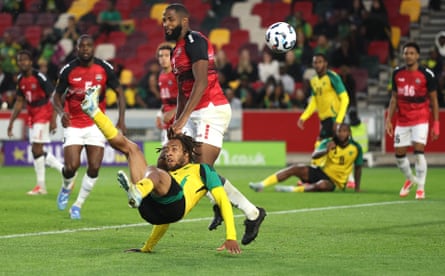 Rumarn Burrell scores Jamaica’s 2nd extremity pinch an overhead footwear during their 3-2 Unity Cup triumph complete Trinidad and Tobago successful May