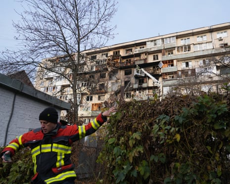Ukrainian rescuers work to extinguish a fire in a damaged residential building following an airstrike in Kyiv.